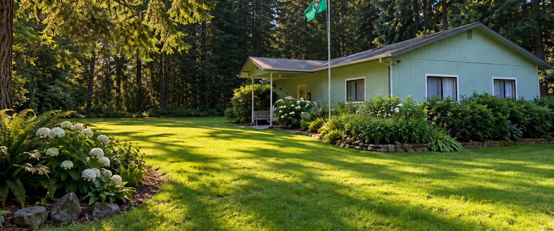Baby Island Saratoga Club clubhouse surrounded by green lawns, flowering gardens, and woodland on Whidbey Island